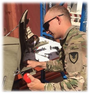 Soldier performing structural repair on Chinook aircraft.